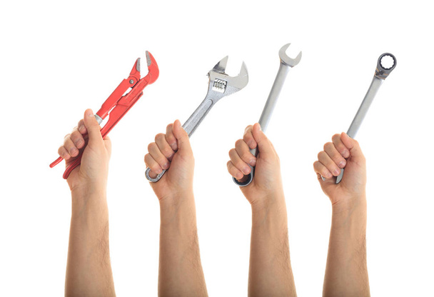 Mains tenant des outils sur fond blanc
 - Photo, image