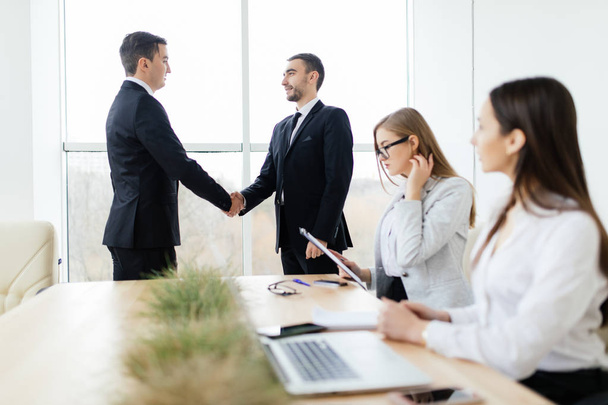 Good deal. Corporate work. Business people handshake in meeting room - 写真・画像