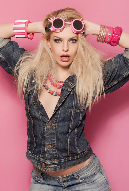 Barbie pop girl portrait wearing jeans jacket and pink accessories - Foto, afbeelding
