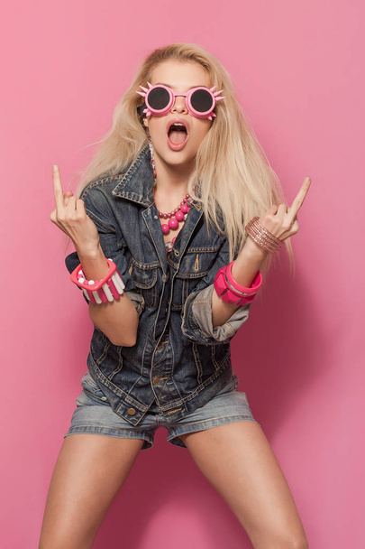 Transgressive Barbie pop girl portrait wearing odd sunglasses - Photo, image