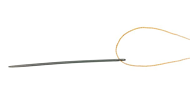 Orange thread through eye of needle - Photo, Image