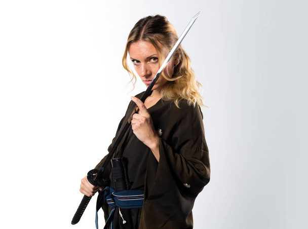 Blonde woman dressed like samurai with a katana - Foto, Bild