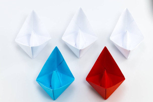 Leadership concept with red paper ship leading among white - Photo, Image