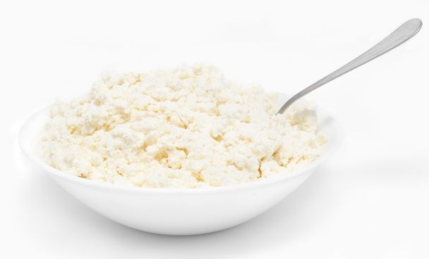 Fresh cottage cheese in the bowl with spoon isolated - Photo, image