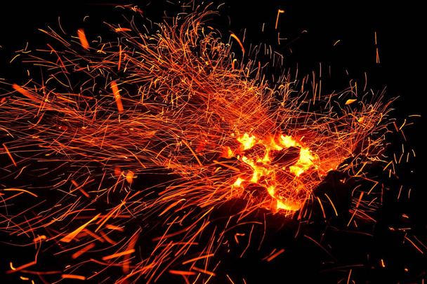 Hot sparking live-coals burning in a barbecue - Photo, Image