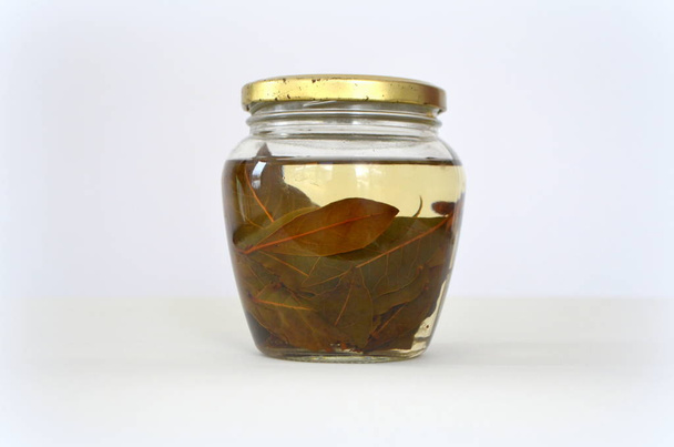 decoction with bay leaves in a jar - Photo, Image