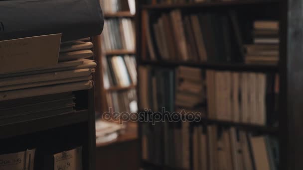 Bookcases full of books and document folders in old style library. Focus pull - Footage, Video