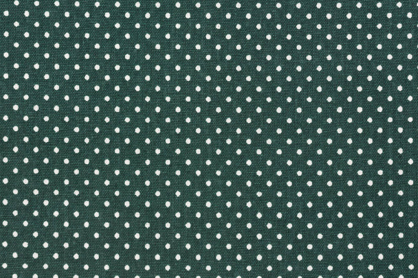 Dark green fabric background with white polka dot pattern. - Photo, Image