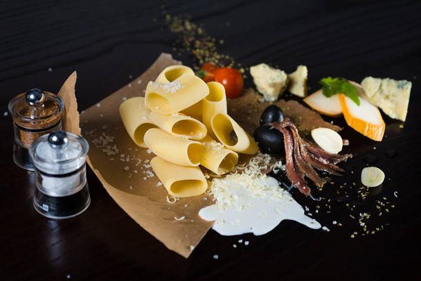 Italian food and ingredients pasta lying on the paper - Φωτογραφία, εικόνα
