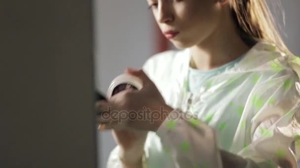 Teen girl in windcheater making makeup before mirror - Záběry, video
