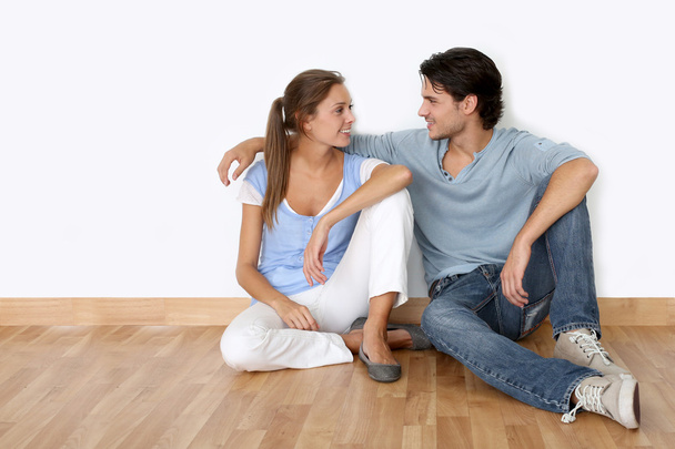 Couple sitting on the floor in new apartment - Photo, Image