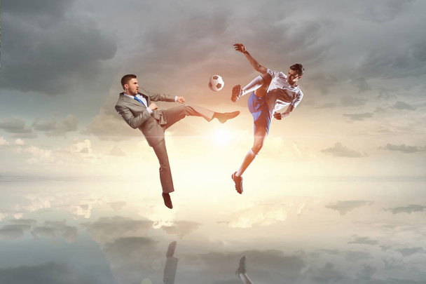 Soccer player kicking ball . Mixed media - 写真・画像