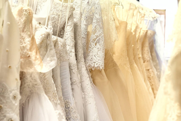 Bunch of wedding dresses horizontal - Fotoğraf, Görsel