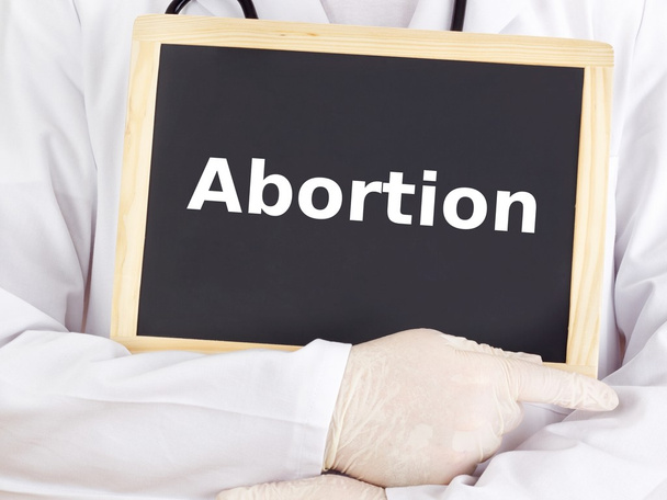 Orvos azt mutatja, információ a tábla: abortusz - Fotó, kép