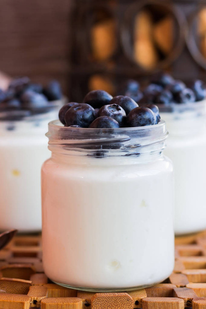 Yogurt with berries in a glass jar - Photo, Image