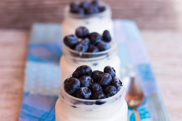 Homemade yogurt with berries in a glass jar - Photo, Image