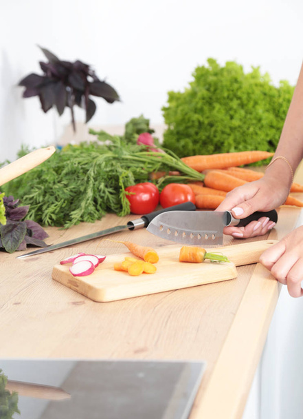 Fresh vegetables on the cutting board are falling in the pot, concept of cooking - Foto, Bild