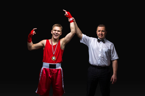 Boxing referee gives medal to young boxer - Photo, Image