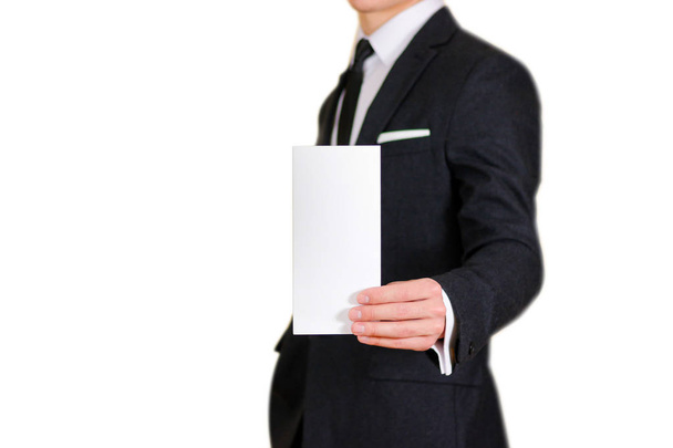 Man showing blank black flyer brochure booklet. Leaflet presenta - Foto, Bild