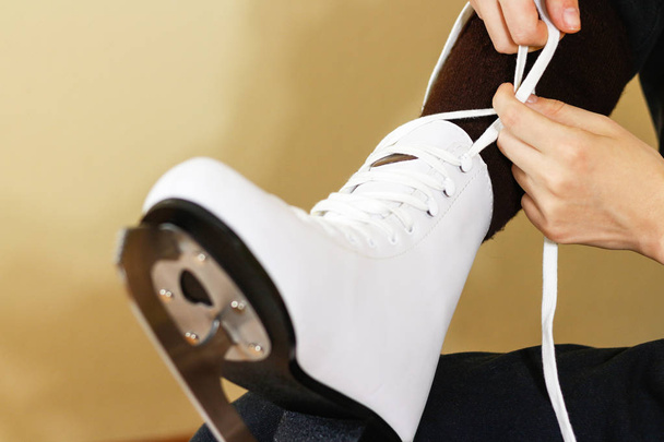 Girl in dress white ice skates mittens tying shoelaces and prepa - Valokuva, kuva
