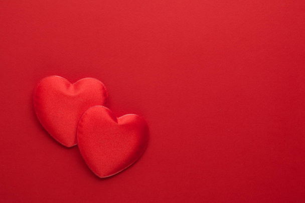 Two decorative hearts are on red paper. Flat lay. - Valokuva, kuva
