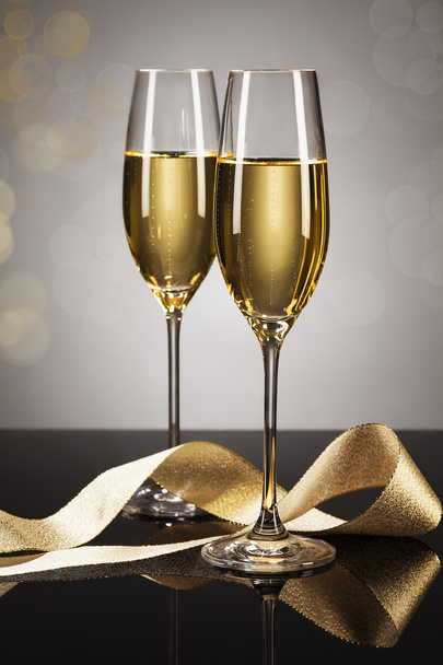 Two glasses of champagne with a golden ribbon - Photo, Image
