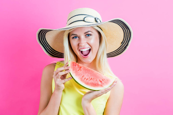 Happy young woman holding watermelon - 写真・画像