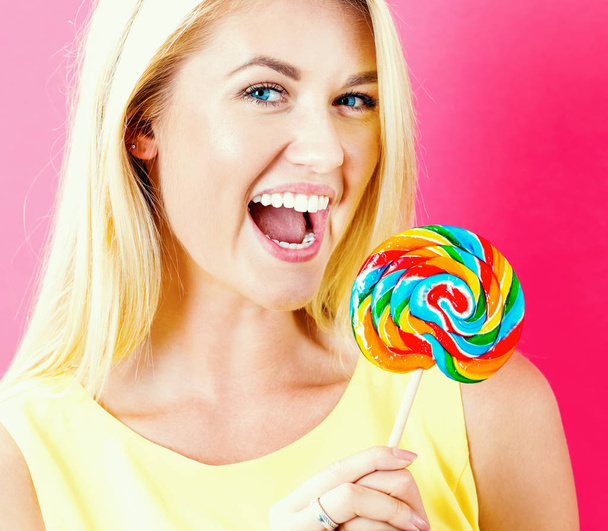 Young woman holding a lollipop - Photo, Image