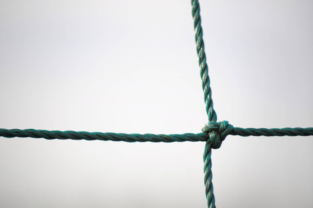 Green twisted rope with a knot - Zdjęcie, obraz