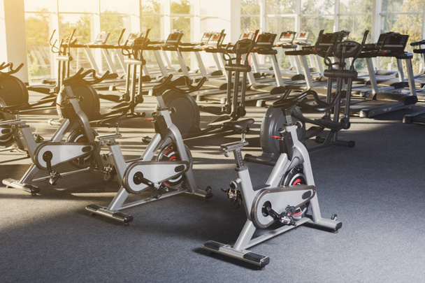 Modern gym interior with equipment, fitness exercise bikes - Photo, Image