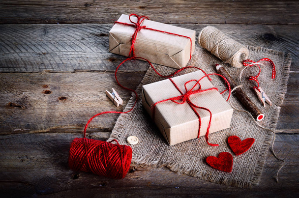 Vintage gift boxes with blank gift tag on old wooden background. - Фото, зображення