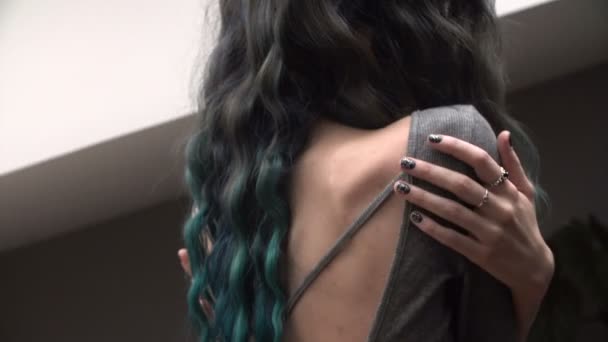 sexy slim girl hugging themselves in the bohemian room. Painted turquoise hair. Close-up. Beautiful back - Footage, Video