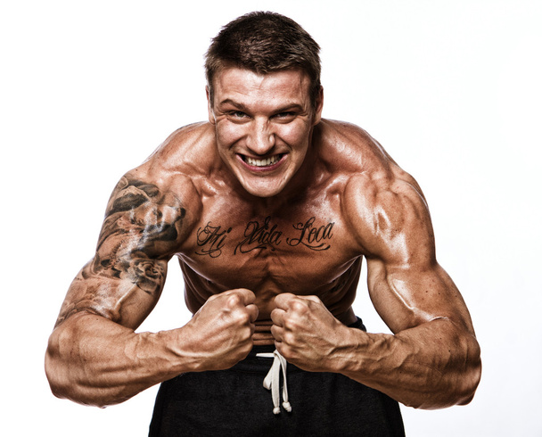 Portrait of handsome bodybuilder posing on white background - Photo, Image