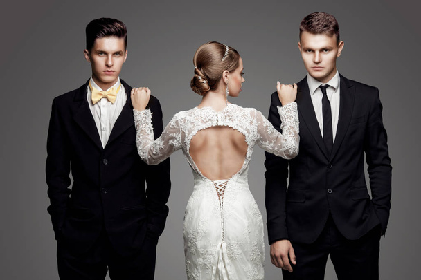Two handsome men and beautiful bride, studio - Valokuva, kuva