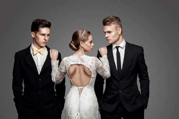 Two handsome men and beautiful bride, studio - Foto, Bild