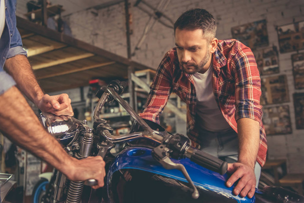 Faceci w sklepie naprawy motocykli - Zdjęcie, obraz