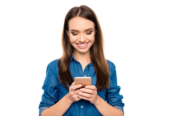 Portrait of pretty glad girl typing sms to her friend - Foto, afbeelding