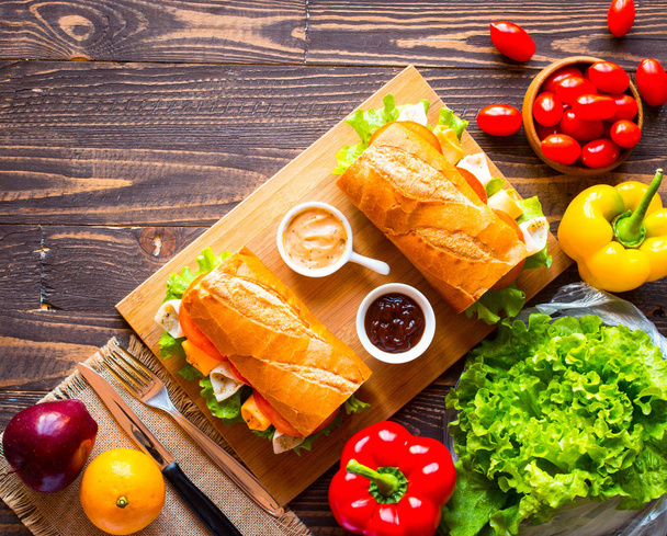 Delicious and Tasty sandwiches with turkey, ham, cheese, tomatoe - 写真・画像