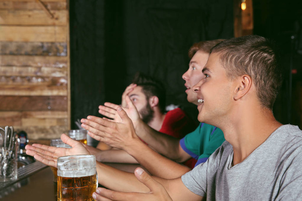 Cheerful friends with beer in sport bar - Fotoğraf, Görsel