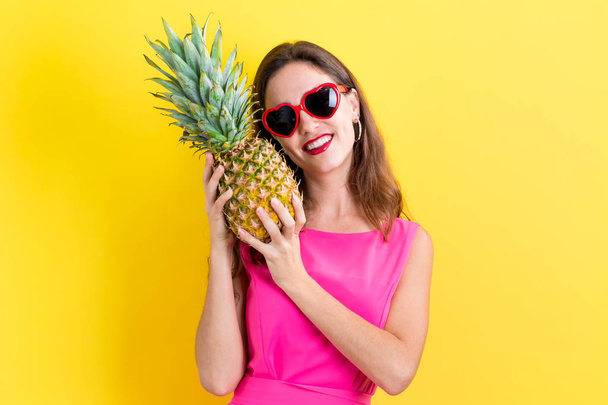 Happy young woman holding a pineapple - Photo, Image
