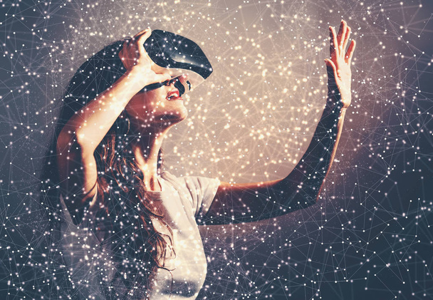 Woman using a virtual reality headset - Foto, afbeelding