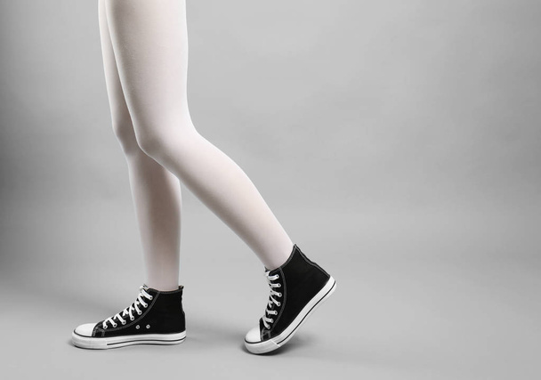 Woman in white tights and sneakers - Foto, immagini