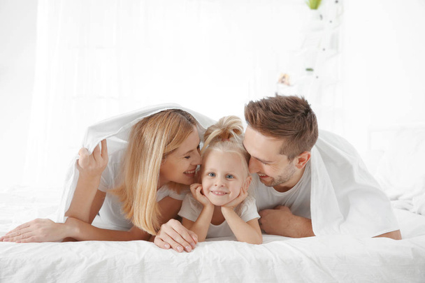 Cute little girl with parents  - Photo, image