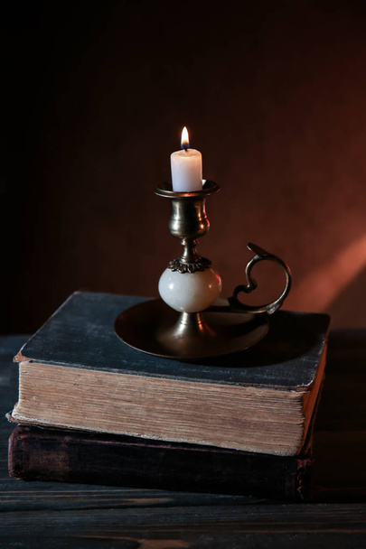 Bible with burning candle - Foto, afbeelding