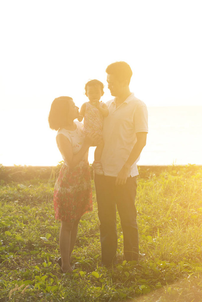 Beautiful family outdoor portrait in sunset - Foto, Imagen