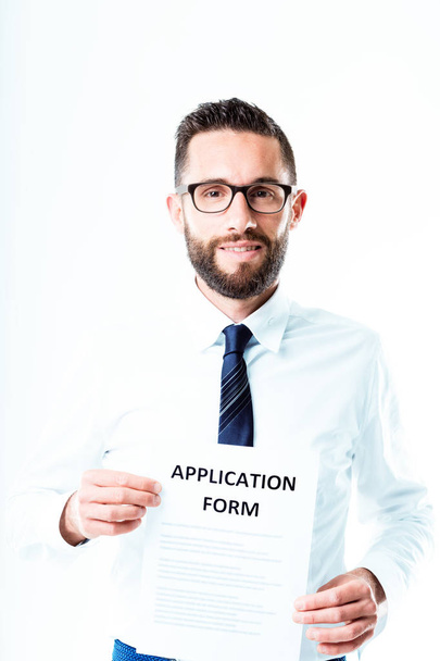 bearded man with glasses and an application form - Φωτογραφία, εικόνα
