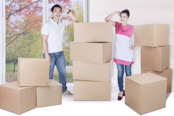Young man and woman stand with box  - Foto, afbeelding
