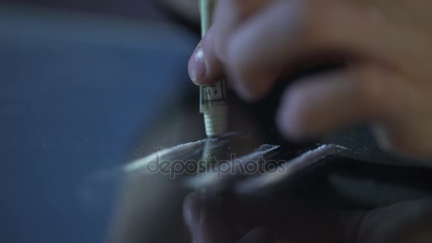 Person inhaling cocaine line through rolled banknote, drug addiction problem - Footage, Video