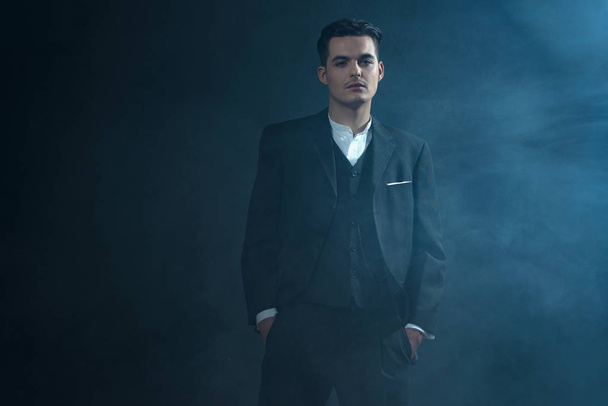 Gangster wearing suit standing in smoke.   - Photo, Image