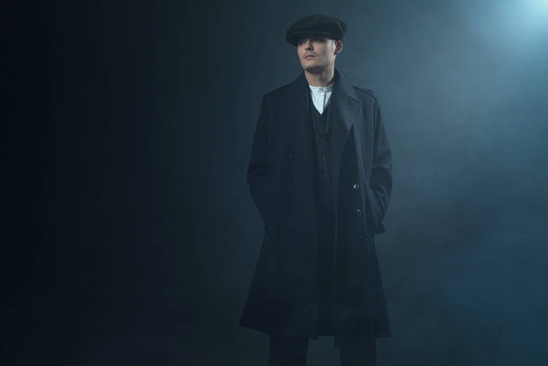 Gangster in flat cap in smoky room.  - Photo, Image